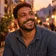 Lucas, homem de barba curta, rindo ao entardecer